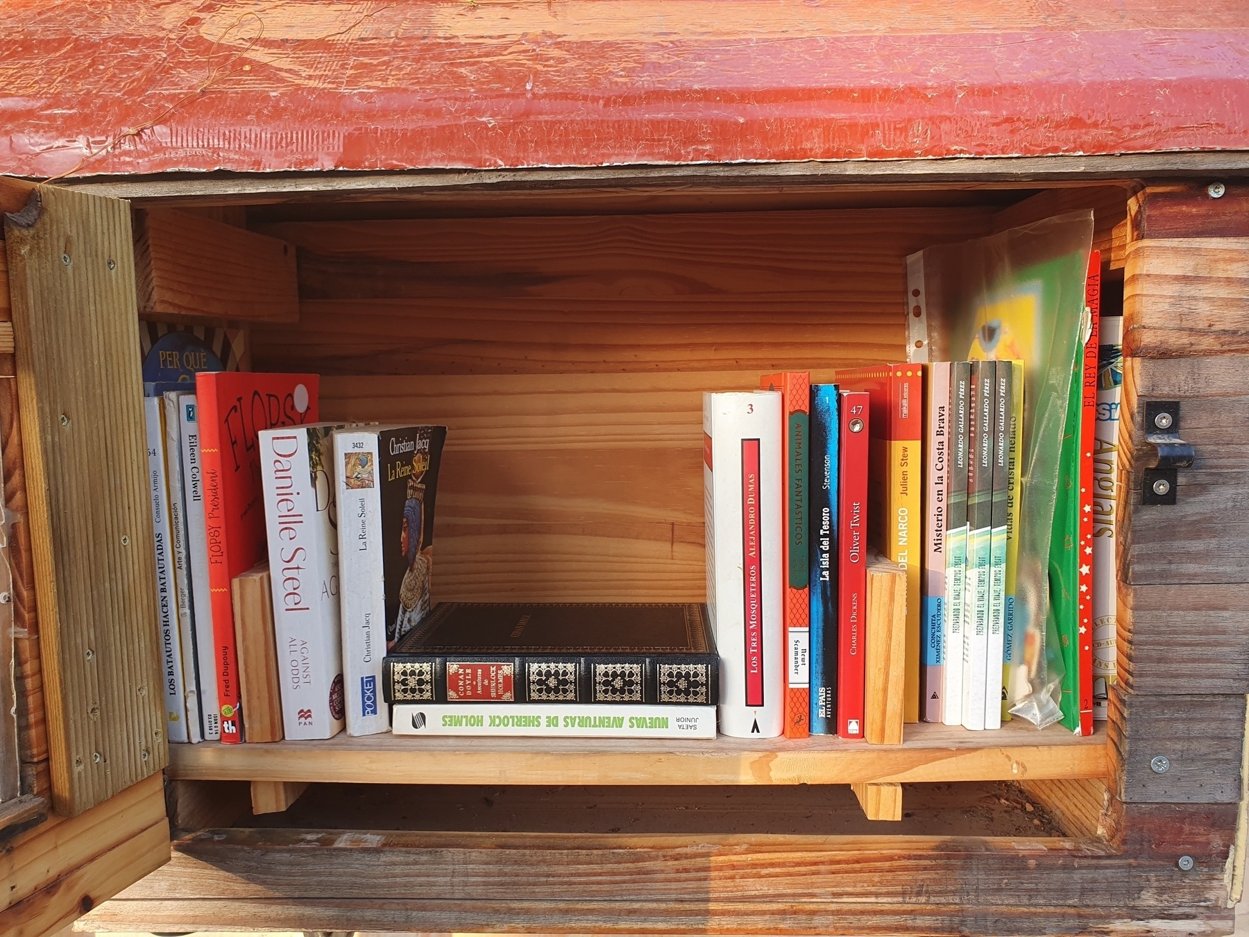 A small wooden bookshelf filled with books.